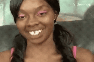 Woman In Pink Eyeshadow And Pigtails Smiling GIF