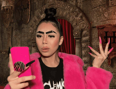 Woman In Pink Fur Coat Taking Selfie GIF