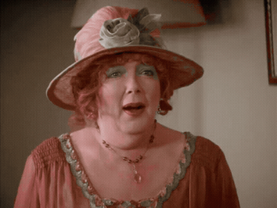Woman In Pink Hat And Necklace GIF