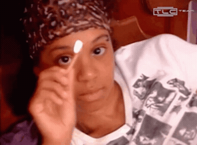 Woman In Pink Hat And Sunglasses Next To Woman In Red Shirt GIF