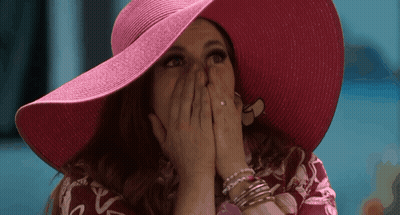 Woman In Pink Hat Covering Mouth GIF
