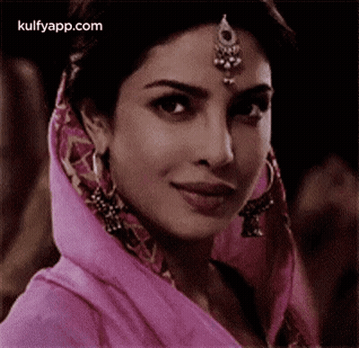 Woman In Pink Head Scarf With Earrings GIF