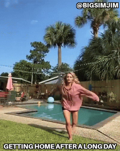 Woman In Pink Hoodie Jumping By Pool Saying Getting Home After A Long Day GIF