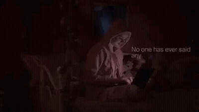 Woman In Pink Hoodie Using Laptop In Bed GIF