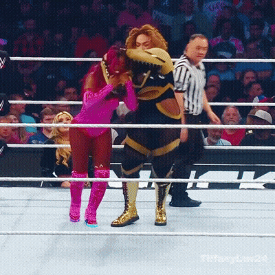 Woman In Pink Hugging Mascot In Ring GIF