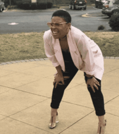 Woman In Pink Jacket And Black Pants Kneeling GIF
