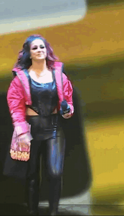 Woman In Pink Jacket And Black Pants Walking Down Street GIF