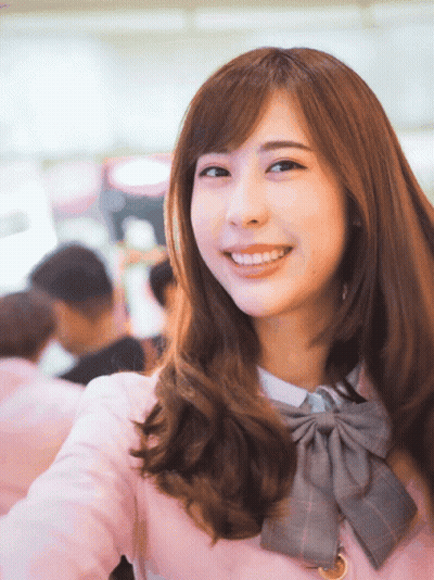 Woman In Pink Jacket And Bow Tie Smiling GIF