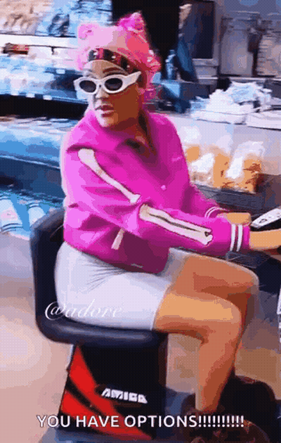 Woman in Pink Jacket and Sunglasses Sitting