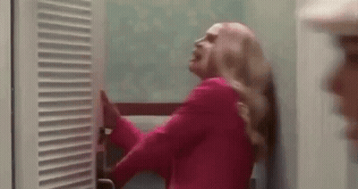 Woman In Pink Jacket At Closet Door GIF