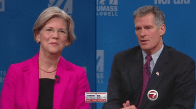 Woman In Pink Jacket Covering Mouth Man In Suit Looking On GIF