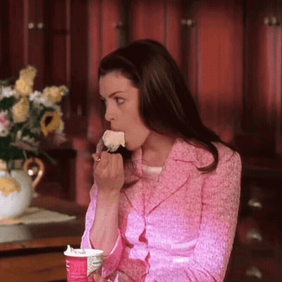Woman In Pink Jacket Eating Cake From Cup GIF