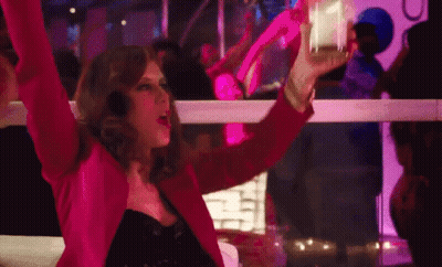 Woman In Pink Jacket Holding Glass At Club GIF