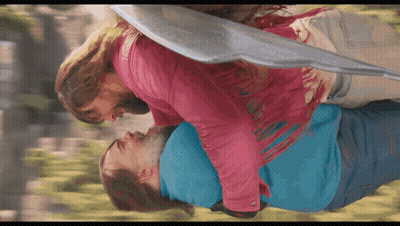 Woman In Pink Jacket Holding Man In Blue Shirt GIF
