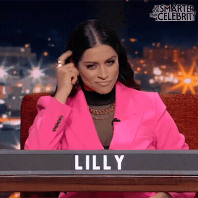 Woman In Pink Jacket In Front Of Lilly Sign GIF