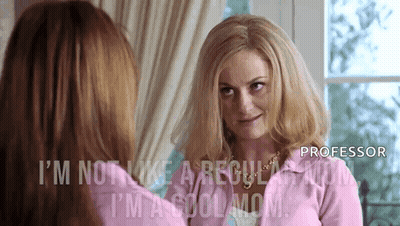 Woman In Pink Jacket Looking In Mirror GIF