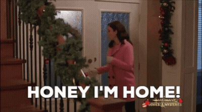 Woman In Pink Jacket Saying Honey I'm Home GIF