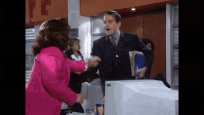 Woman In Pink Jacket Shaking Hands With Man In Suit GIF