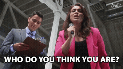 Woman in Pink Jacket Singing Into Microphone