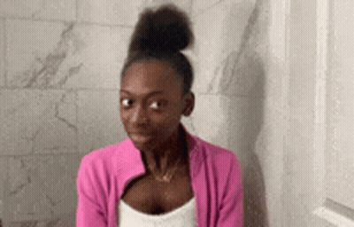 Woman In Pink Jacket Sitting On Toilet GIF