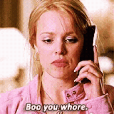 Woman In Pink Jacket Talking On Cell Phone Saying Boo You Whore GIF