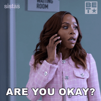 Woman In Pink Jacket Talking On Phone Saying You Okay GIF