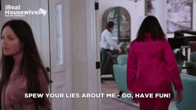 Woman In Pink Jacket Walking Hallway Saying Spew Your Lies About Me GIF