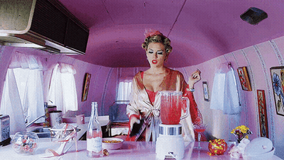Woman In Pink Kitchen With Blender And Water GIF