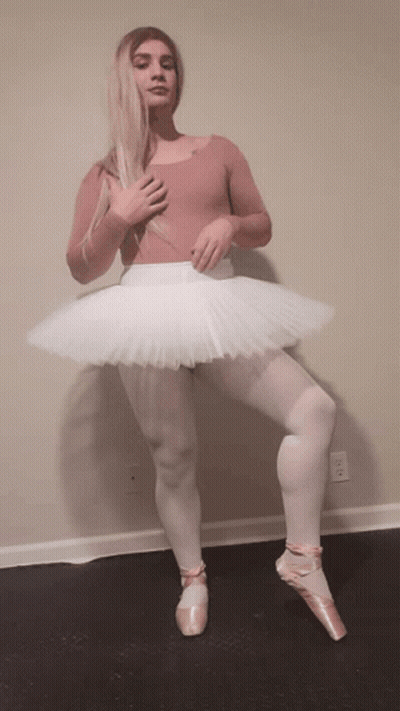 Woman In Pink Leotard And White Tutu Standing On One Leg GIF