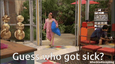 Woman In Pink Pajamas Holding Blue Pillow Man Behind GIF