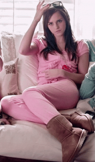 Woman In Pink Pajamas On Couch With Lollipop GIF