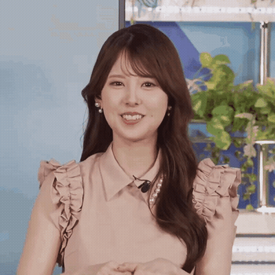 Woman In Pink Ruffled Top Smiling GIF