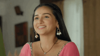 Woman In Pink Saree And Pearl Earrings Smiling GIF