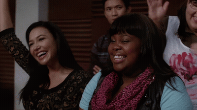 Woman In Pink Scarf Smiling Beside Another GIF