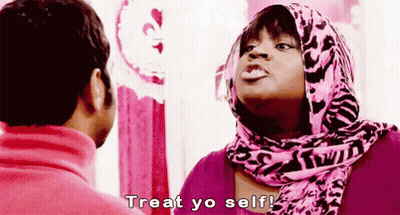 Woman In Pink Scarf Talking To Man In Pink Sweater GIF