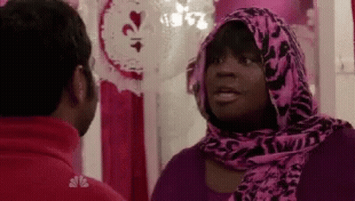 Woman In Pink Scarf Talking To Man In Red Shirt GIF