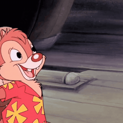 Woman In Pink Scrub Top Talking To Man In Mask GIF