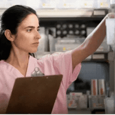 Woman In Pink Scrubs Reaching For Bottle GIF