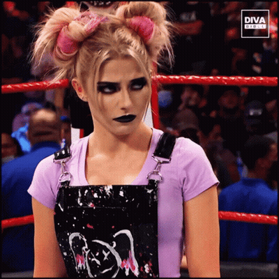 Woman In Pink Shirt And Black Skirt In Front Of Diva Digital Screen GIF