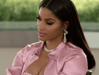 Woman In Pink Shirt And Earrings Sitting GIF