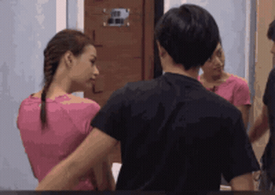 Woman In Pink Shirt And Man In Black Shirt Mirror GIF