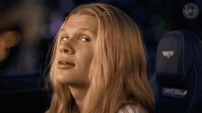 Woman In Pink Shirt And Purple Jacket Smiling GIF