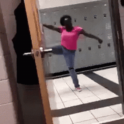 Woman In Pink Shirt Dancing In Locker Room GIF