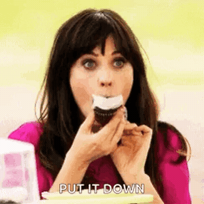Woman In Pink Shirt Eating Frosted Cupcake GIF