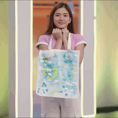 Woman In Pink Shirt Holding Blue And White Tote Bag With Yellow Heart GIF