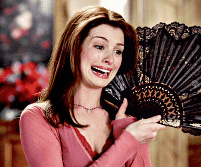 Woman In Pink Shirt Holding Fan With XXX GIF
