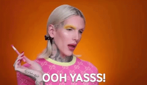 Woman In Pink Shirt Holding Pencil Saying Ooh Yasss GIF