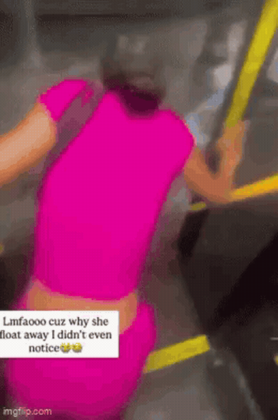 Woman In Pink Shirt Holding Railing On Bus GIF