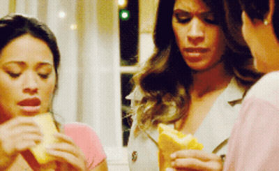 Woman In Pink Shirt Holding Sandwich GIF
