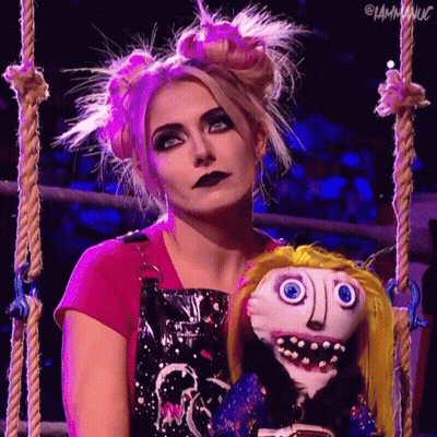 Woman In Pink Shirt Holding Stuffed Doll With Face GIF
